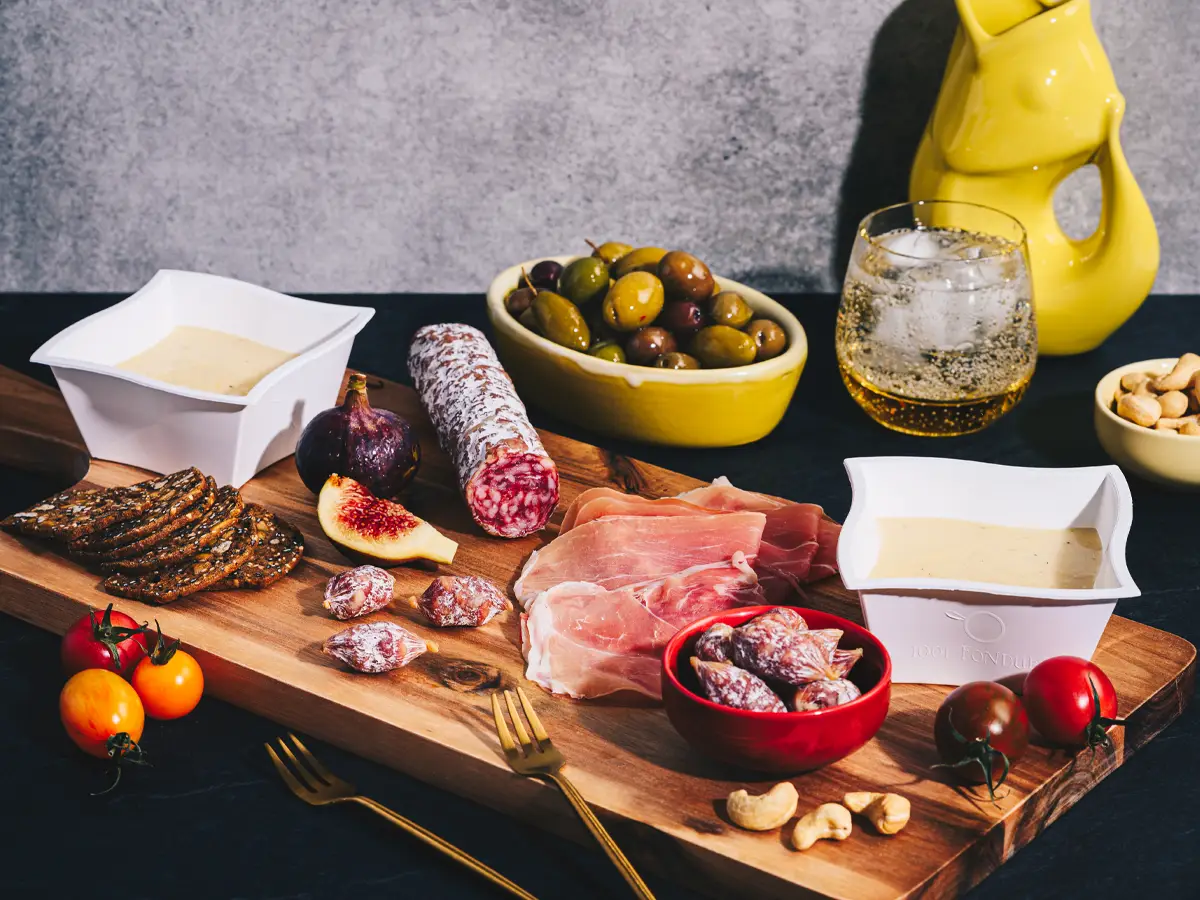 Appetizer board with fondue and accompaniments